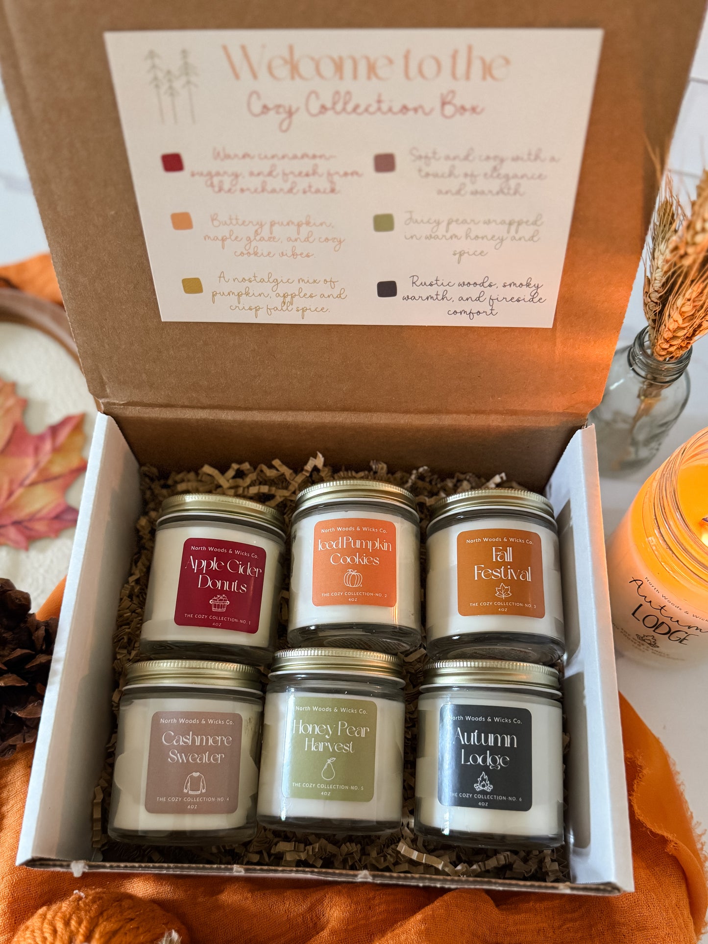 Box of candles with labels in a decorative setting