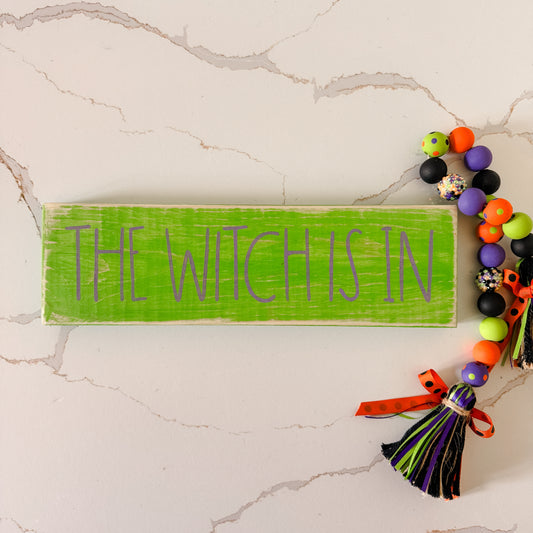 The Witch Is In Halloween wood sign in green and purple, spooky handmade decor