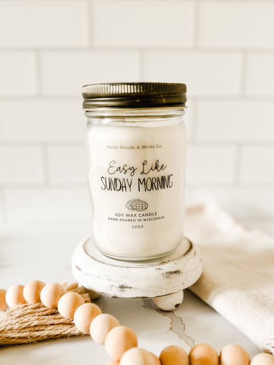 sweet breakfast candle in mason jar, styled on a white background with minimal farmhouse decor.